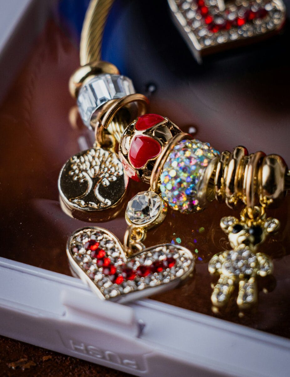 Close-up of a phone case decorated with colorful charms