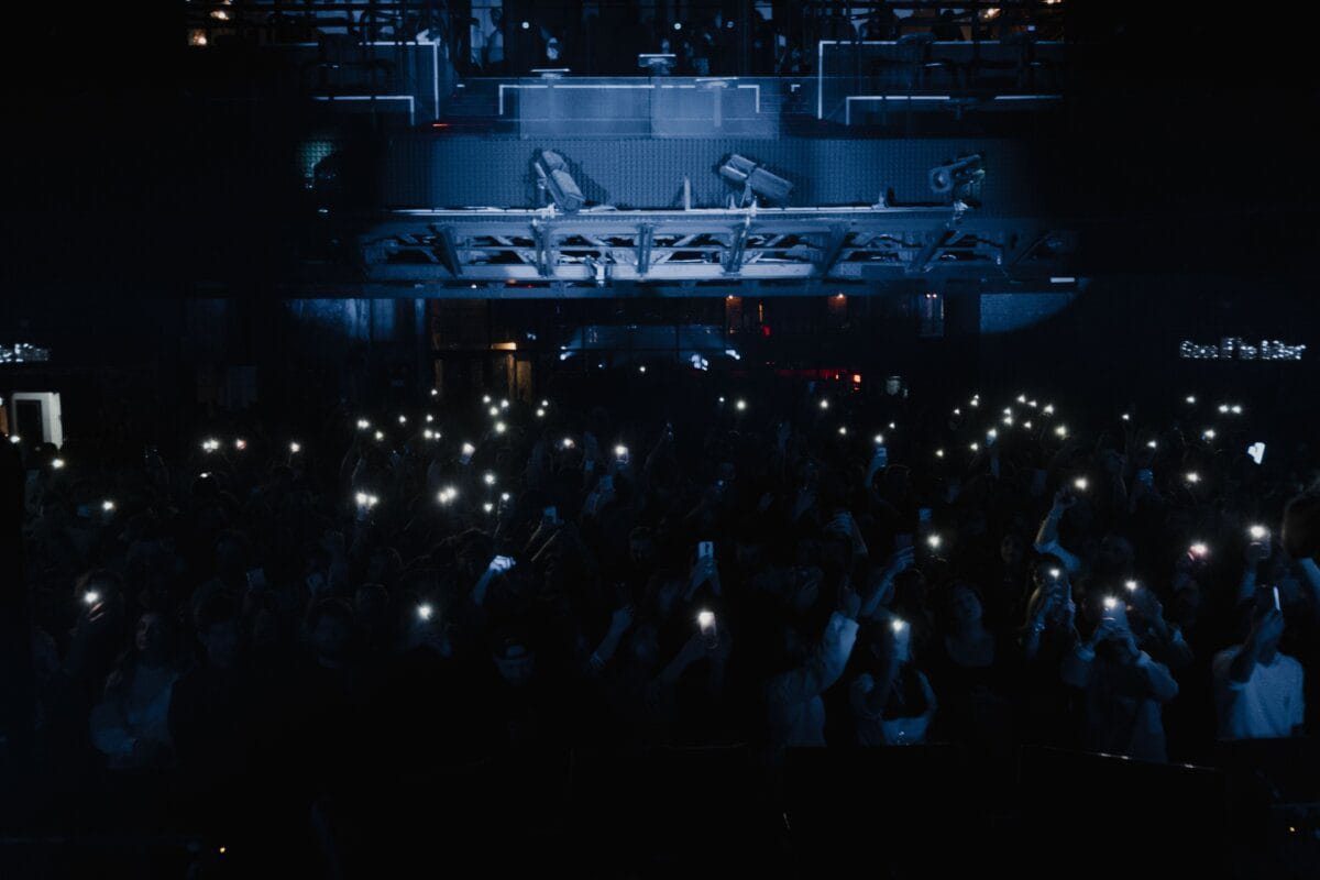 Concert crowd holding up glowing phone lights
