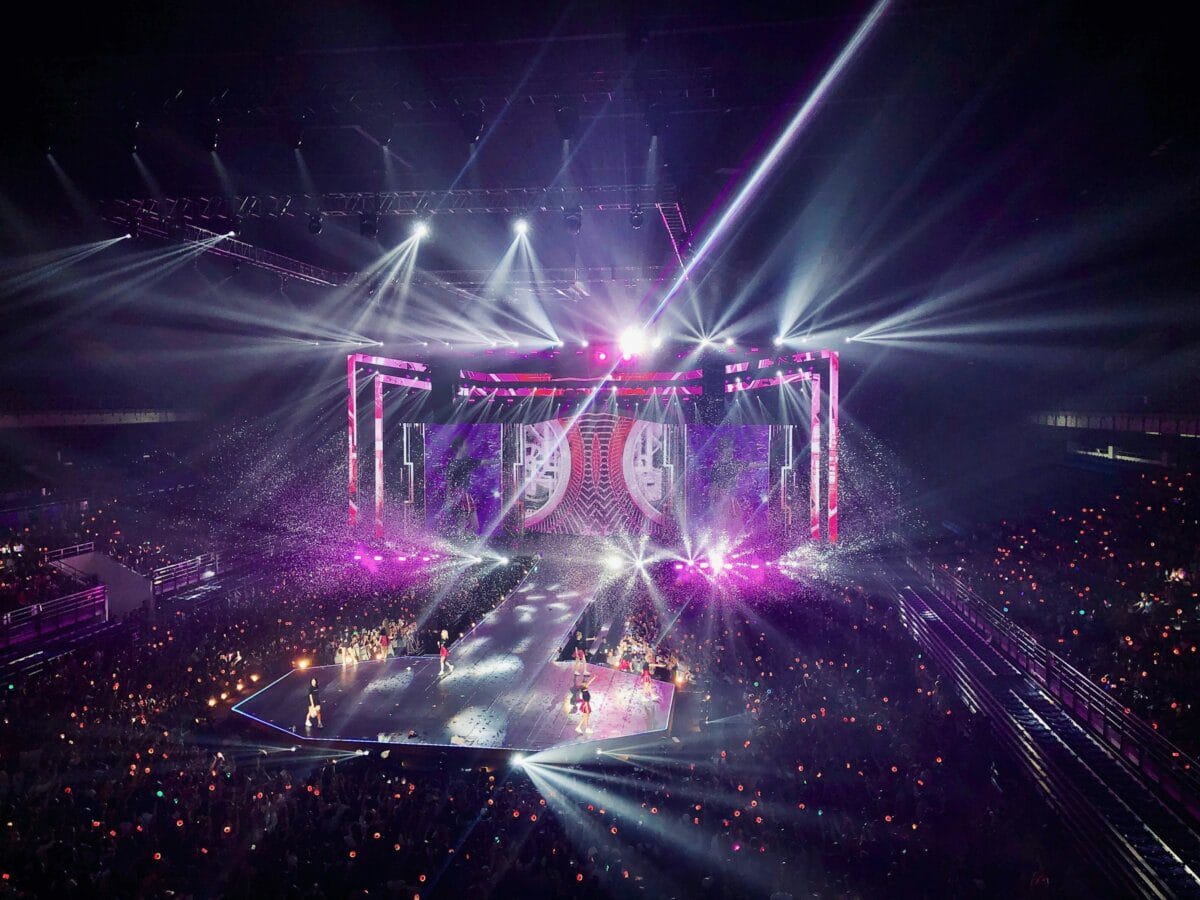 Fans watching a live performance near the stage