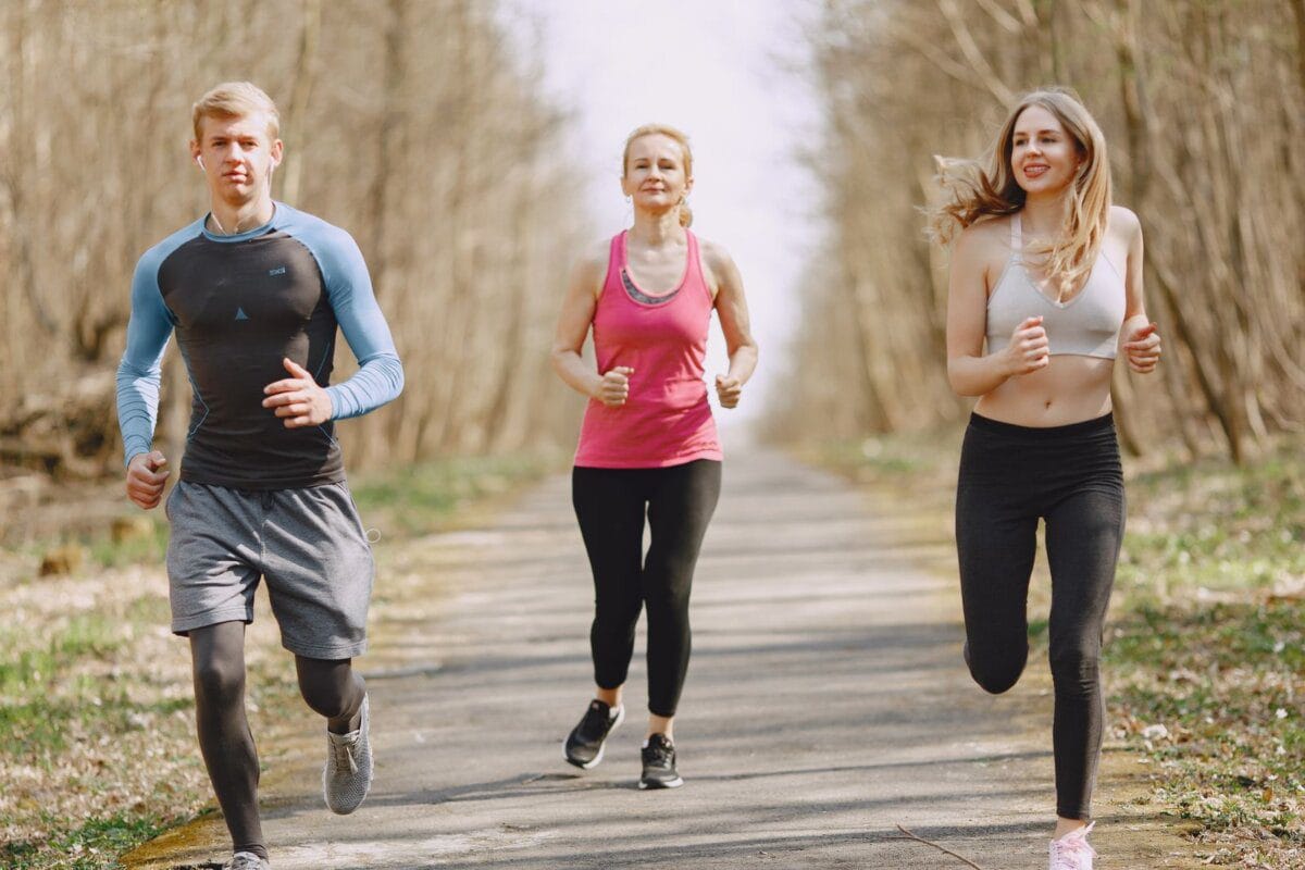 A group of people jogging together on a park path
