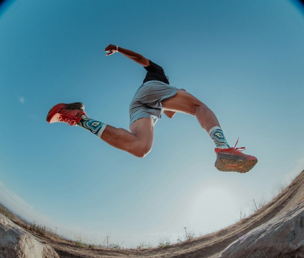 Trail runner on a dirt path, representing the ultrarunning roots of toe socks
