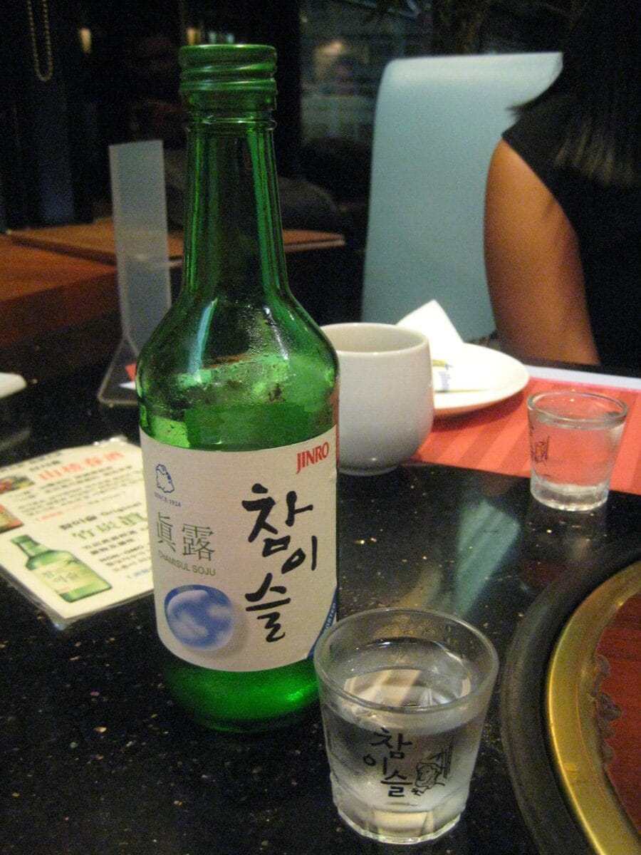 A bottle of soju with a glass on a restaurant table in Korea