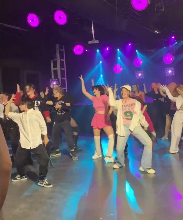 Stray Kids members performing choreography on stage