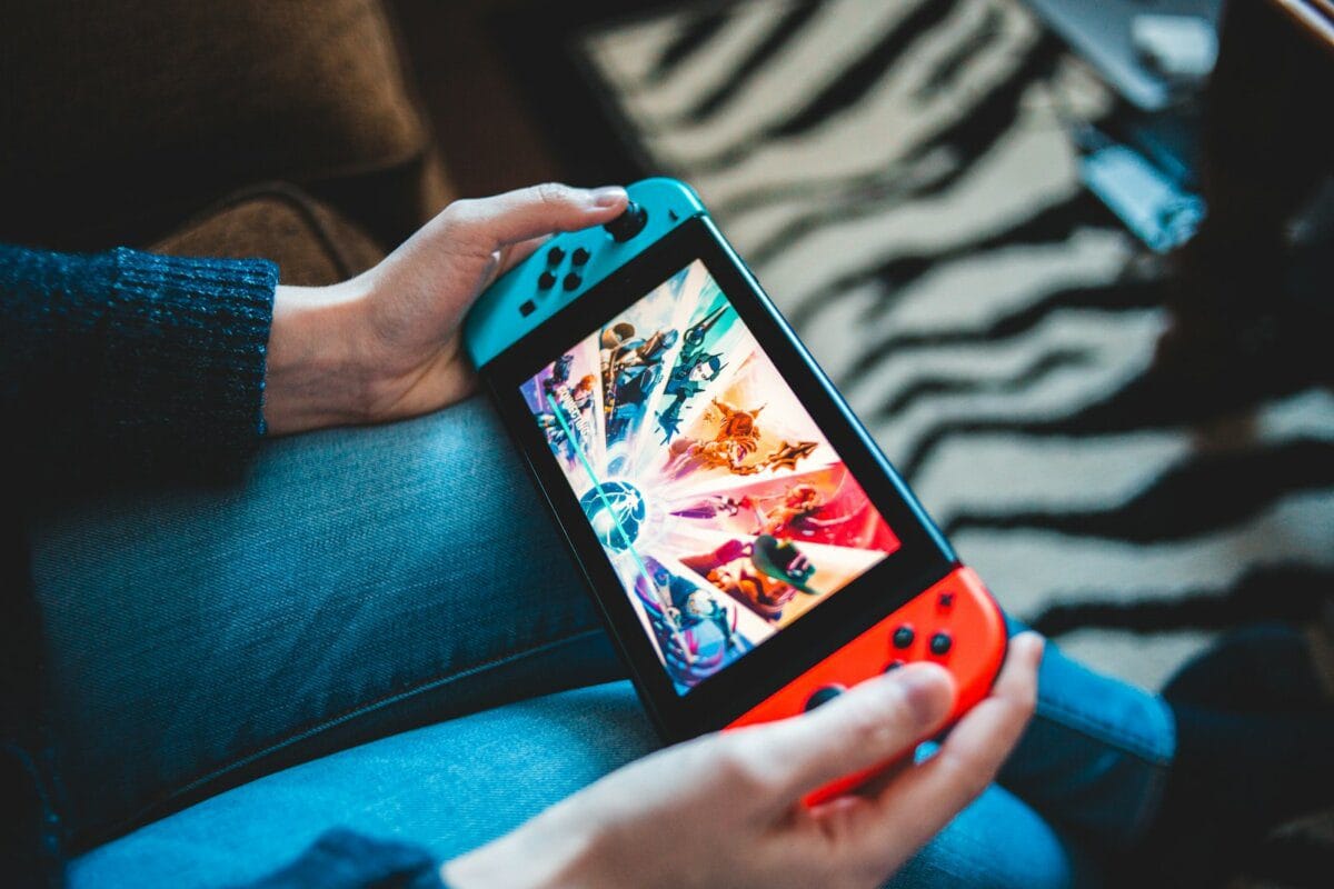 A person relaxing on a couch watching TV with a remote control